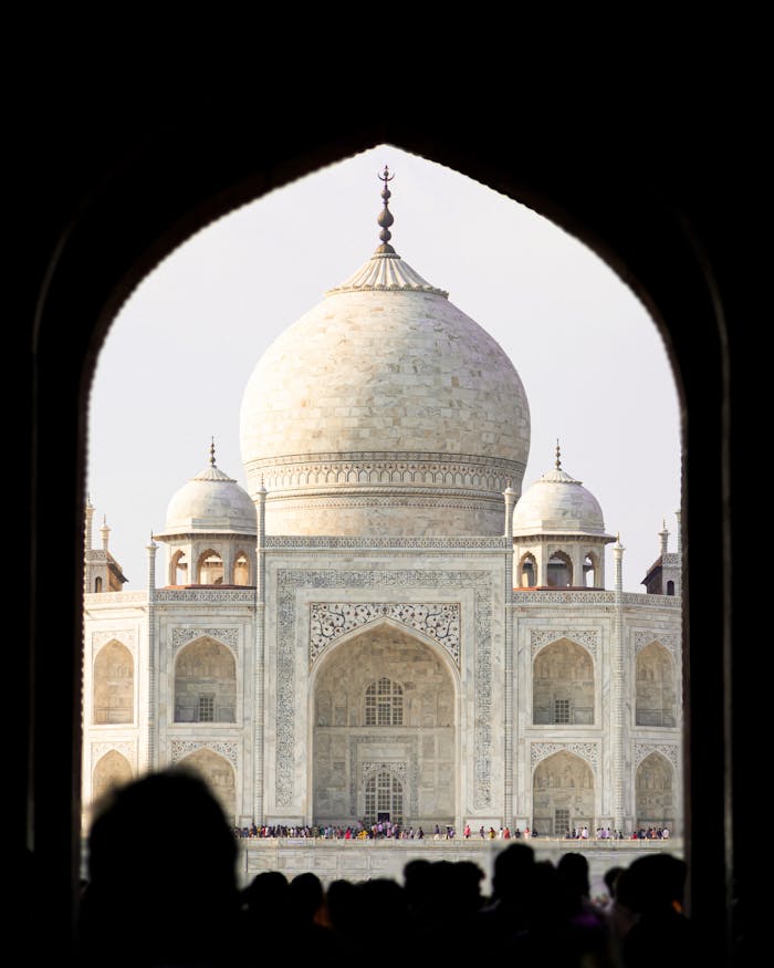 A stunning view of the Taj Mahal framed by an archway in Agra, India.