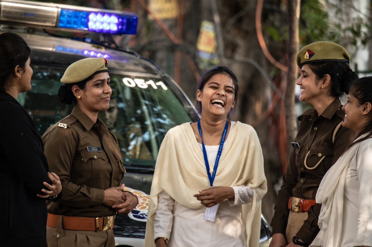 Cheerful Indian policewomen sharing a moment with a woman in Uttar Pradesh.